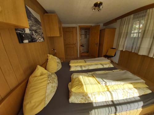 a room with two beds in a room at Mesnerhof Virgen in Virgen