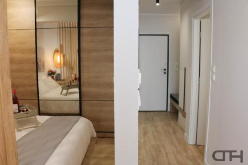 a bedroom with a bed and a room with a mirror at Luxury 80m2 apartment with balcony downtown Thessaloniki in Thessaloniki