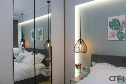 a bedroom with a mirror and a bed at Luxury 80m2 apartment with balcony downtown Thessaloniki in Thessaloniki