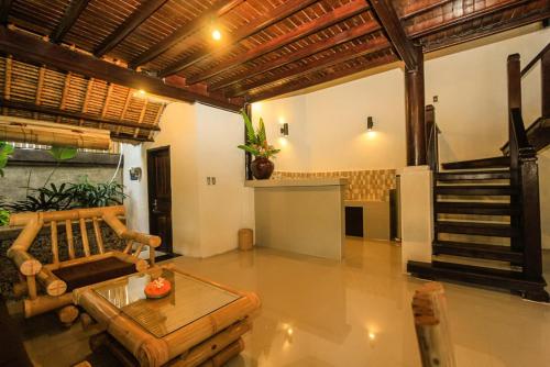 a living room with a couch and a table at Radiant Jepun Villa in Legian