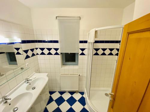 a bathroom with a tub and a sink and a shower at RIVIERA LIPNO 502 Apartmán 4kk u vody in Lipno nad Vltavou
