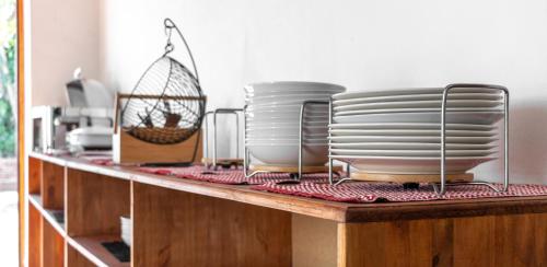 a counter with plates and dishes on a shelf at Anoud Manor in Hout Bay