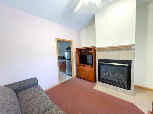a living room with a couch and a fireplace at Lake Bluff Inn and Suites in South Haven