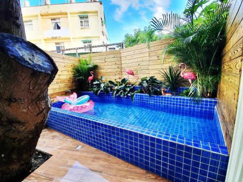 a swimming pool in a backyard with plants at MiM House in Hengchun