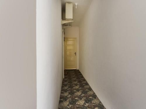 um corredor vazio com uma parede branca e uma porta em OYO 3907 Mine Residence em Padang