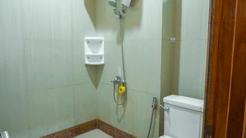 a bathroom with a shower stall with a toilet at OYO 1209 Tirtasari Nice Guesthouse in Bandung