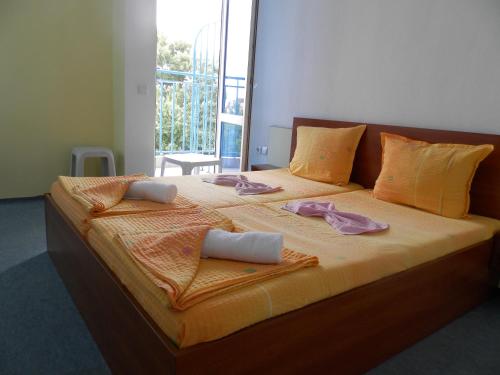 a large bed with towels on top of it at Hotel North in Primorsko