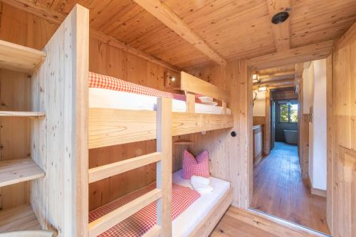 a wooden cabin with two bunk beds in it at Golmerhaus in Schruns-Tschagguns