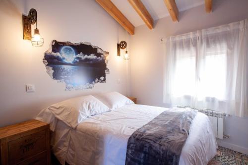 a bedroom with a bed and a window at APARTAMENTOS LA VIEJA IMPRENTA in Sigüenza