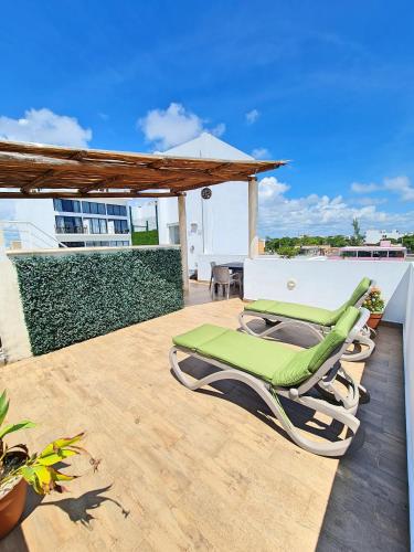 a pair of chaise lounge chairs on a patio at Playa Nah in Playa del Carmen