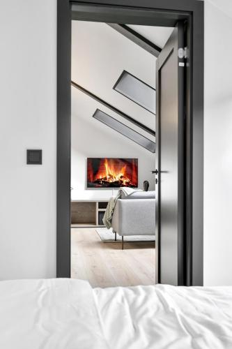 a bedroom with a bed and a fireplace in a room at In the heart of Narvik ! in Narvik