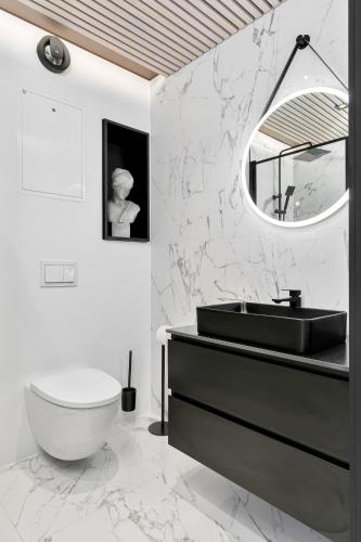 a bathroom with a black sink and a mirror at In the heart of Narvik ! in Narvik