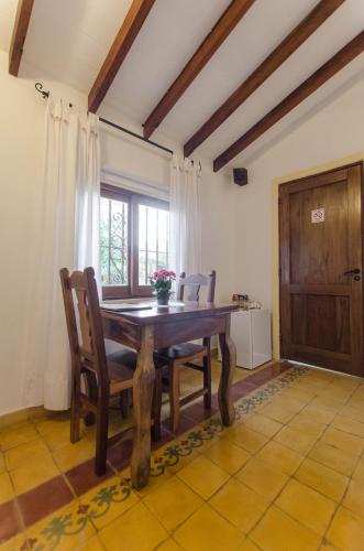 a dining room with a wooden table and chairs at La Casona Hotel Boutique in Asuncion