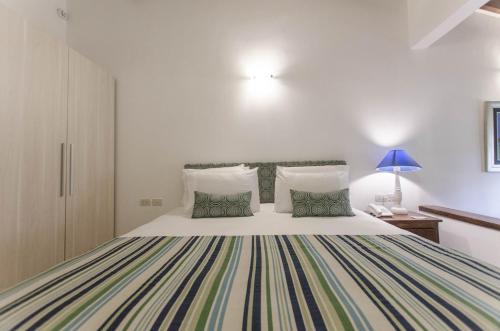 a bedroom with a large white bed with two pillows at La Casona Hotel Boutique in Asuncion