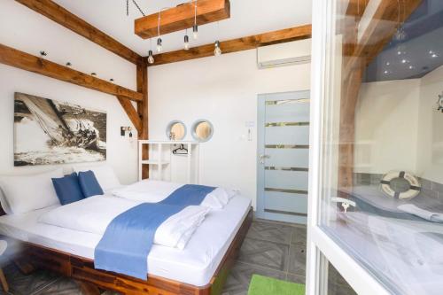 a bedroom with a bed and a glass door at Dunakavics Boutique Apartman Szentendre in Szentendre