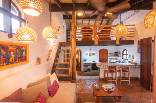 a living room filled with furniture and a large window at Sueño del Mar Beachfront Hotel in Tamarindo