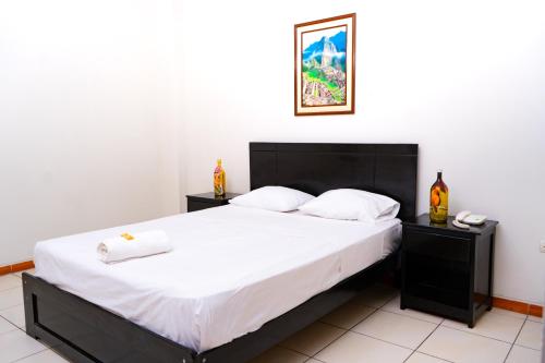a bedroom with a large bed with white sheets at Residencial Brest Amazon Tarapoto in Tarapoto