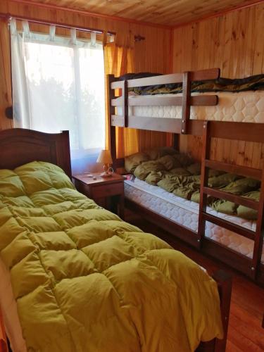 a bedroom with two bunk beds in a cabin at WilAnn SPA in Pichilemu