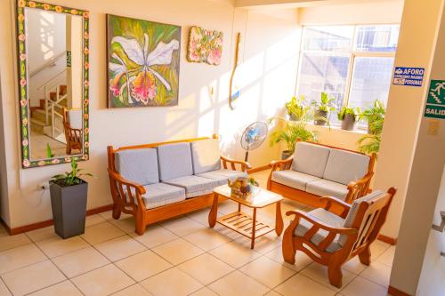 two chairs and a table in a room with plants at Residencial Brest Amazon Tarapoto in Tarapoto