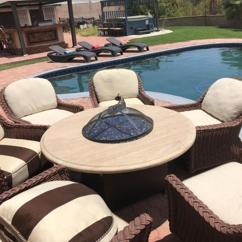 a table and chairs next to a pool at paradise luxury experience in Woodland Hills