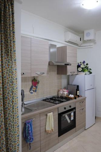a kitchen with a sink and a stove top oven at Casetta di Diego in Tivoli