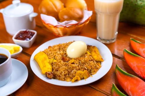 a plate of food with an egg on a table at Residencial Brest Amazon Tarapoto in Tarapoto