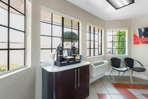 a home office with a desk and two chairs and windows at Motel 6-Merced, CA - North in Merced