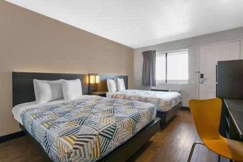 a hotel room with two beds and a window at Motel 6-Merced, CA - North in Merced