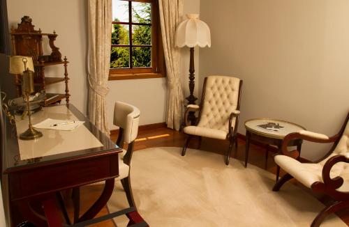 a living room with a desk and a chair and a table at Rinoterra Minho in Caminha