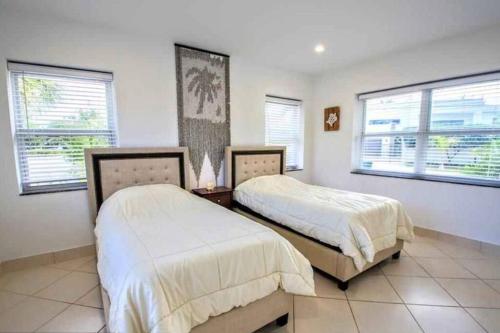 Кровать или кровати в номере SWAYING PALM BEACH HOUSE