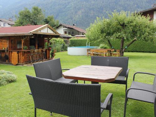 a table and chairs in a yard with a house at Haus Wammes in Silz