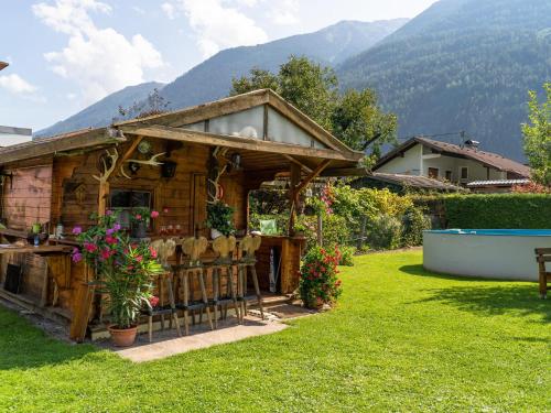 a wooden house with a table and chairs in a yard at Haus Wammes in Silz