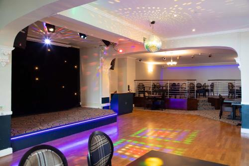 a ballroom with a stage and a dance floor at The Marine Hotel in Llandudno