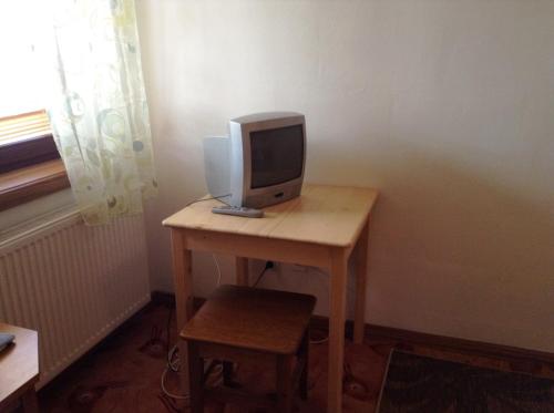a computer monitor sitting on top of a desk at Ubytovanie Anka Sučanská in Čachtice
