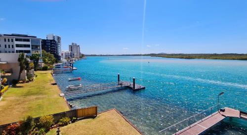 a large body of water with boats in it at Wharf Lodge River View Apartment in Maroochydore