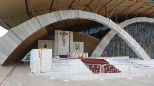 an altar in a church with a cross on the wall at Hotel Vittoria in San Giovanni Rotondo
