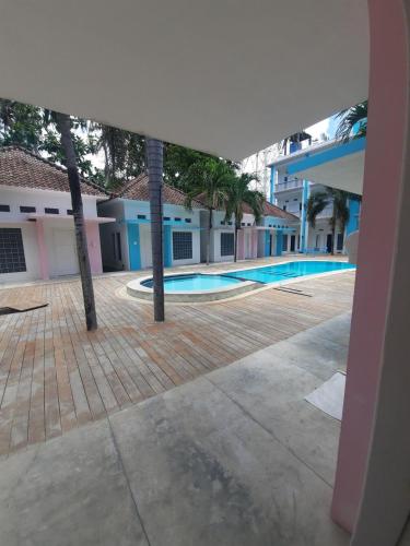 a view of the courtyard of a building with a swimming pool at Mad Monkey Kuta Lombok in Kuta Lombok