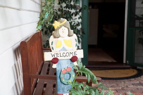 a welcome sign in front of a house at Rosebridge House Bed & Breakfast Adult Retreat in Gooseberry Hill