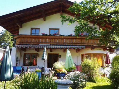 a house with umbrellas in front of it at Ferienwohnungen Obex in Mieders