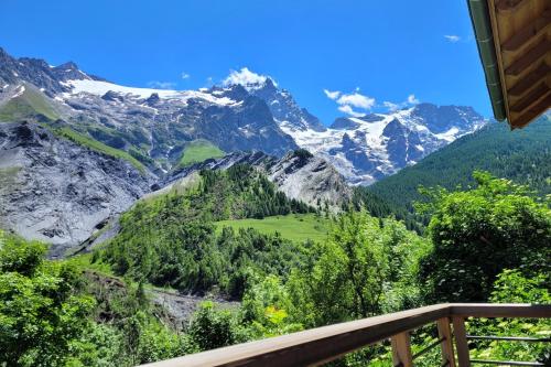 a view of a mountain valley from a balcony at Chalet l'ecrin - 6 pers with panoramic view of the Meije in La Grave