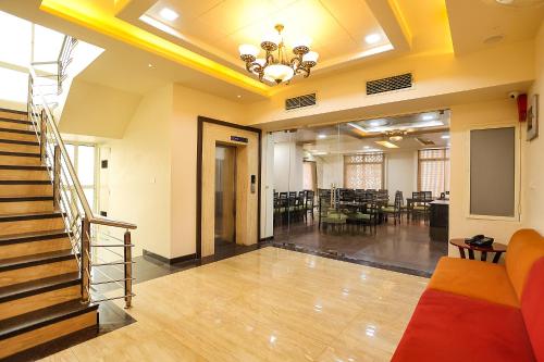a room with a staircase and a dining room at Royal GM Plaza in Jaipur