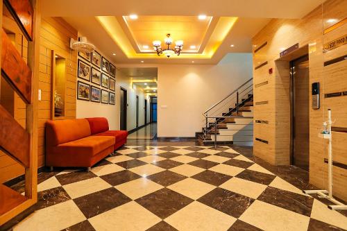 a lobby with a couch and a checkered floor at Royal GM Plaza in Jaipur
