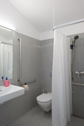 a bathroom with a toilet and a sink and a shower at Stein am Rhein Youth Hostel in Stein am Rhein