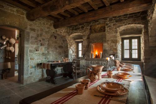 a dining room with a table and a fireplace at Eremito in Parrano