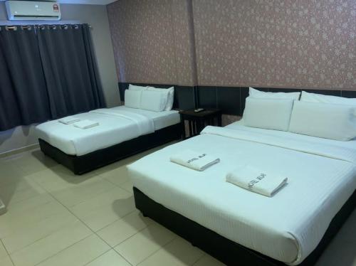 Ένα ή περισσότερα κρεβάτια σε δωμάτιο στο Hotel Jelai @ Mentakab