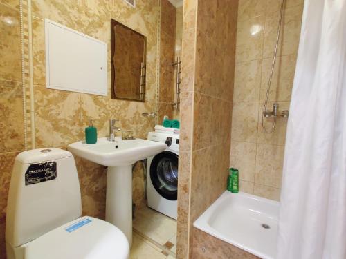 a bathroom with a toilet and a sink and a shower at Apartment on Internacionalnaya 34 in Bobruisk