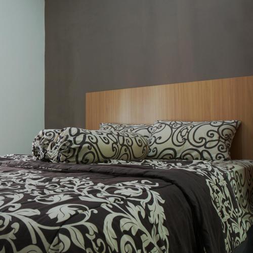 Кровать или кровати в номере Djuragan Kamar Kayon