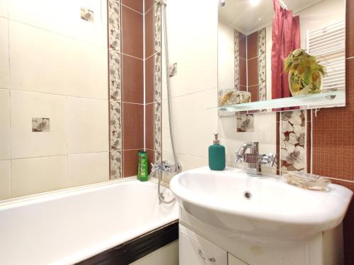 a bathroom with a sink and a tub and a toilet at Apartament on Sovetskaya 135 in Bobruisk
