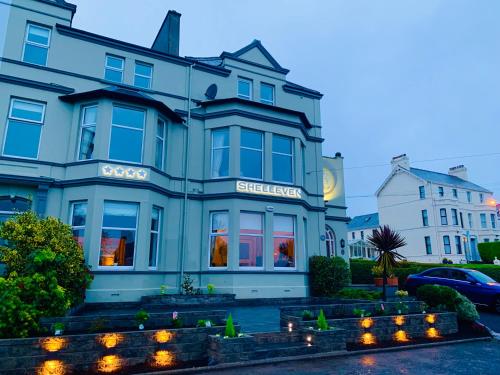 a blue building with lights in front of it at Shelleven Guest House in Bangor