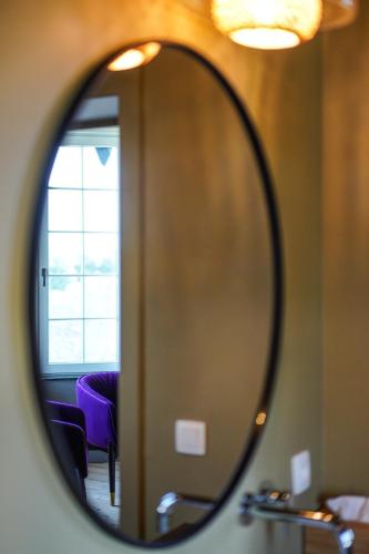 a mirror reflection of a room with a window at Les Terrasses des Falizes B&B in Rochefort